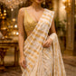 IVORY COLOUR CHANDERI GOLDEN STRIPED PARSI EMBROIDERED SAREE PAIRED WITH AN UNSTITCHED GOLDEN BLOUSE BY SIDDHAIKA