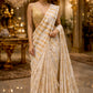 IVORY COLOUR CHANDERI GOLDEN STRIPED PARSI EMBROIDERED SAREE PAIRED WITH AN UNSTITCHED GOLDEN BLOUSE BY SIDDHAIKA
