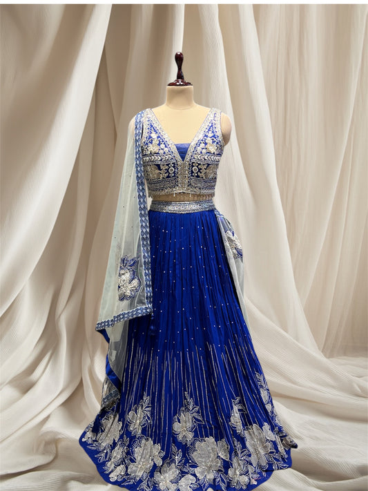 ( DELIVERY IN 50 DAYS ) ROYAL BLUE COLOUR CRUSH SILK LEHENGA WITH APPLIQUE WORK PAIRED WITH OFFWHITE NET APPLIQUE WORK DUPATTA & SEQUENCE, BEADS EMBROIDERY BLOUSE