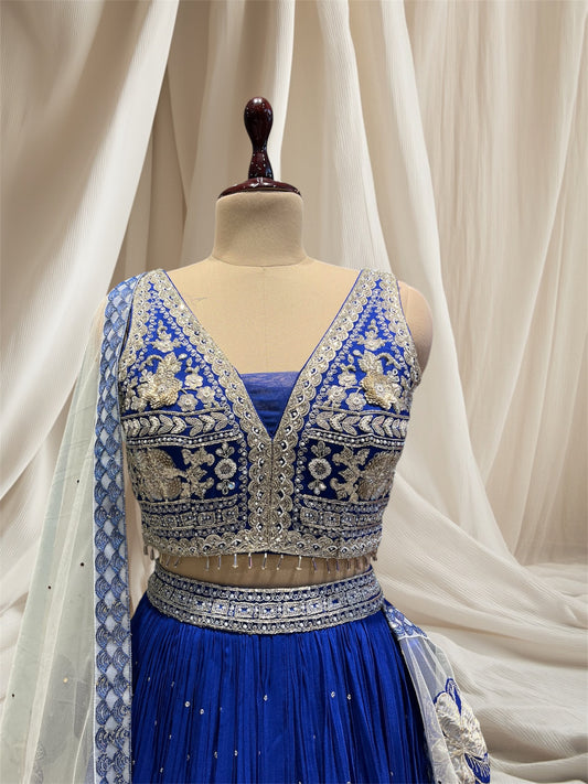 ( DELIVERY IN 50 DAYS ) ROYAL BLUE COLOUR CRUSH SILK LEHENGA WITH APPLIQUE WORK PAIRED WITH OFFWHITE NET APPLIQUE WORK DUPATTA & SEQUENCE, BEADS EMBROIDERY BLOUSE