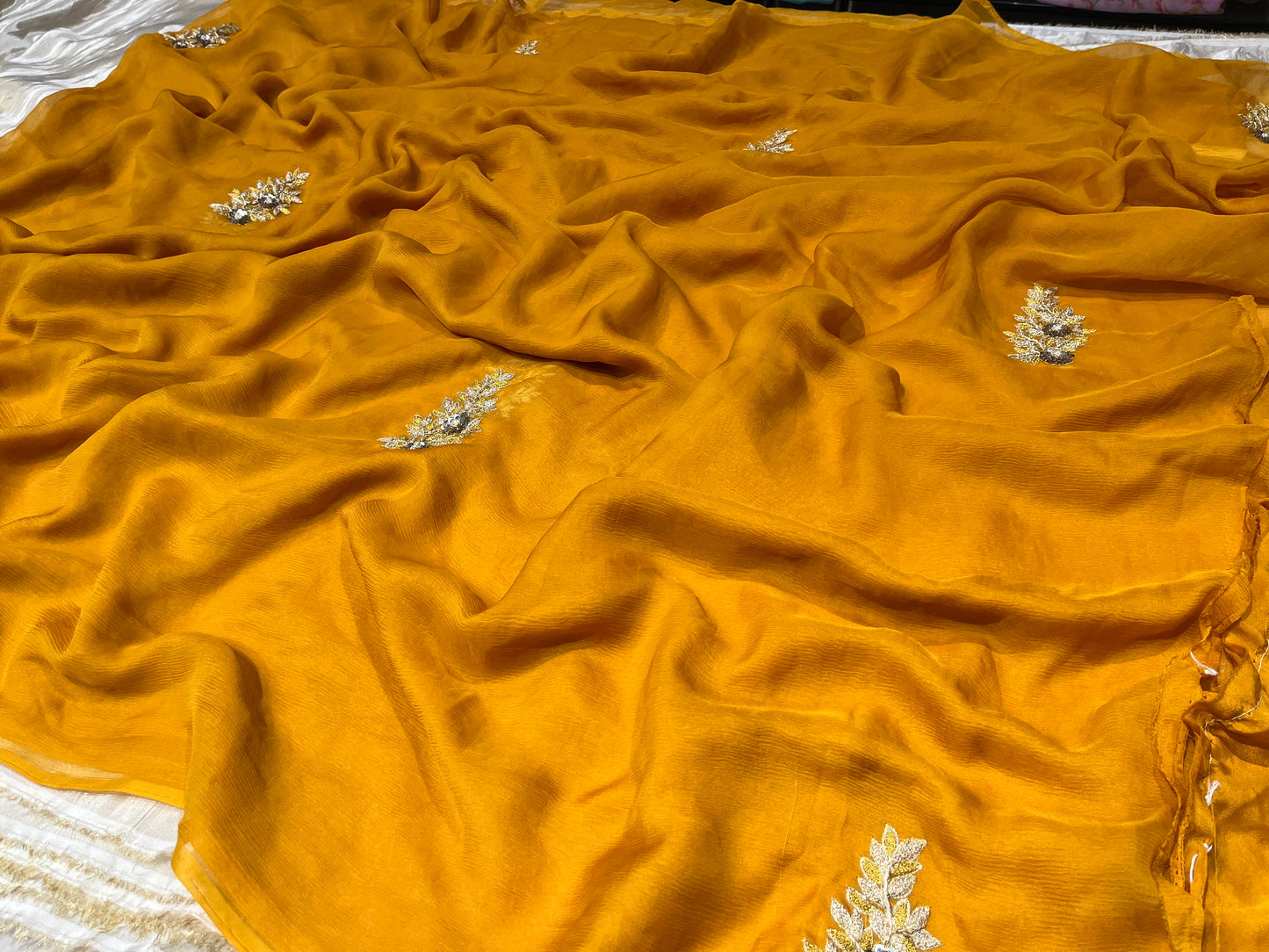 ( DELIVERY IN 25 DAYS ) MUSTARD COLOUR PURE CHIFFON HAND EMBROIDERED SAREE EMBELLISHED WITH ZARDOZI WORK