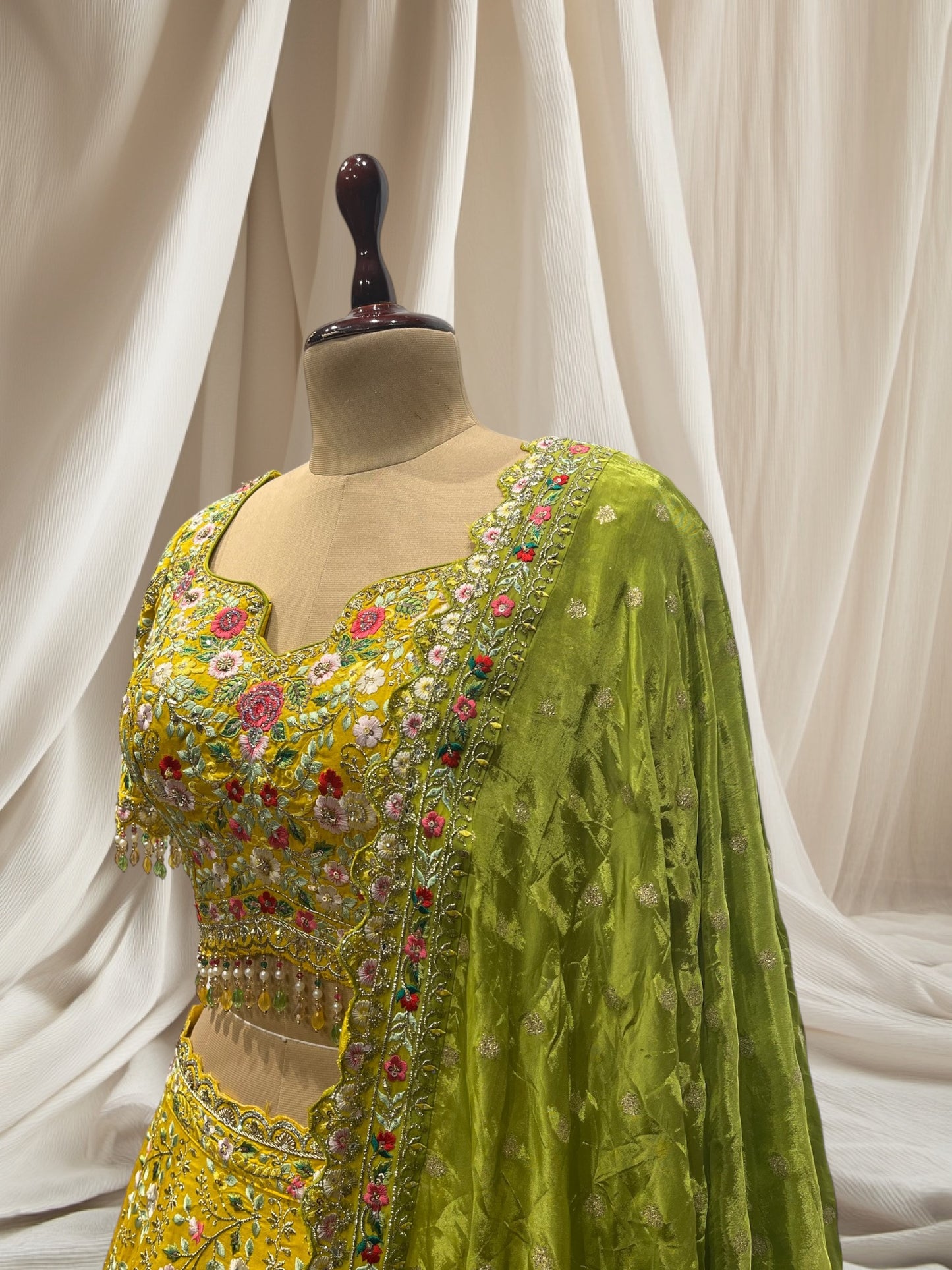 LEMON YELLOW LEHENGA WITH GREEN DUPATTA, SILK FABRIC, & RESHAM WORK EMBELLISHED WITH BEADS & TASSELS