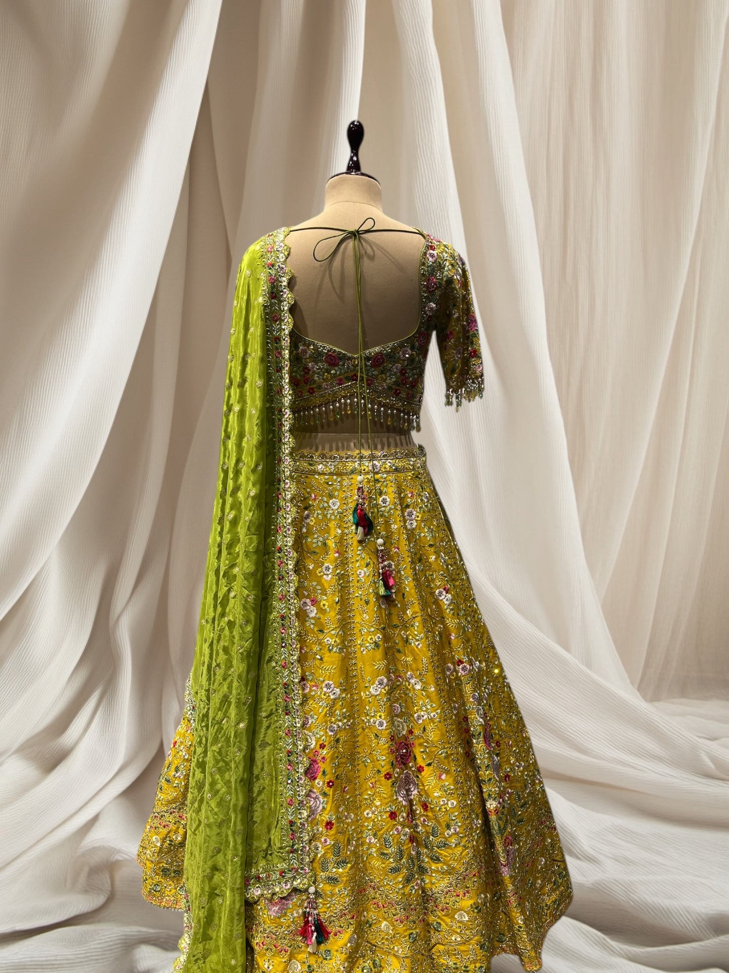 LEMON YELLOW LEHENGA WITH GREEN DUPATTA, SILK FABRIC, & RESHAM WORK EMBELLISHED WITH BEADS & TASSELS