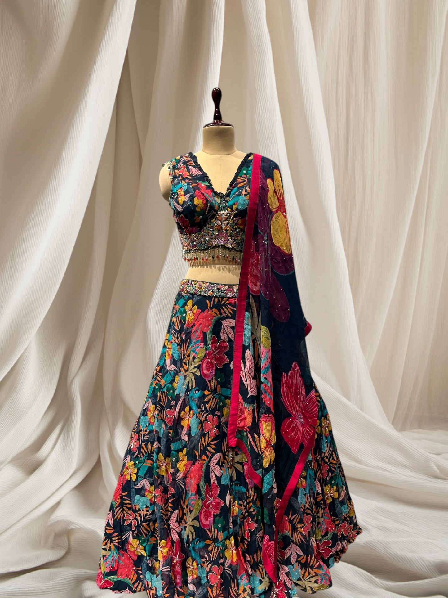 NAVY BLUE COLOUR, MULTI COLOR PRINT ORGANZA LEHENGA WITH V NECK CROP TOP & ORGANZA DUPATTA EMBELLISHED WITH BEADS & SEQUINS TASSELS