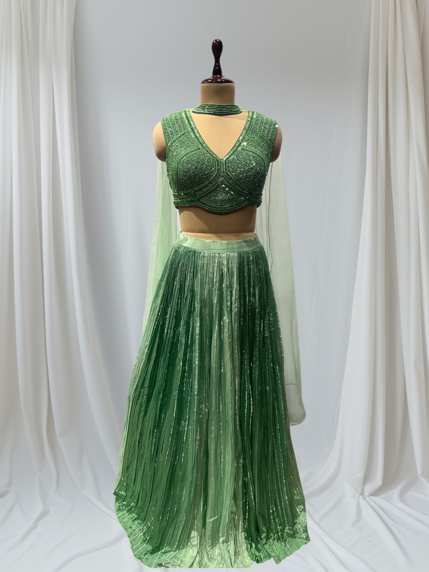 GREEN COLOR, SILK LEHENGA WITH V-NECK CROP TOP & NET DUPATTA EMBELLISHED WITH SEQUINS EMBROIDERY