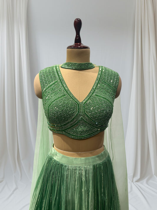 GREEN COLOR, SILK LEHENGA WITH V-NECK CROP TOP & NET DUPATTA EMBELLISHED WITH SEQUINS EMBROIDERY