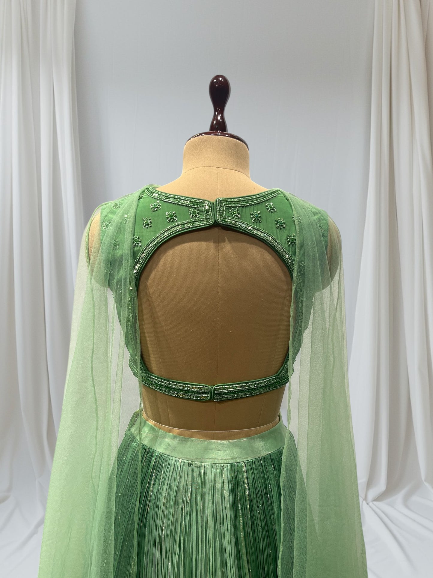 GREEN COLOR, SILK LEHENGA WITH V-NECK CROP TOP & NET DUPATTA EMBELLISHED WITH SEQUINS EMBROIDERY