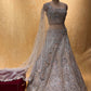 ( DELIVERY IN 25 DAYS ) GREY COLOR NET EMBROIDERED LEHENGA WITH UNSTITCHED BLOUSE EMBELLISHED WITH ZARI & SEQUINS WORK