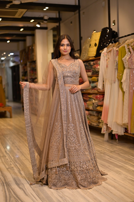 ( DELIVERY IN 15-20 DAYS ) BEIGE COLOUR GEORGETTE EMBROIDERED LEHENGA WITH CROP TOP BLOUSE & NET DUPATTA EMBELLISHED WITH MIRROR WORK