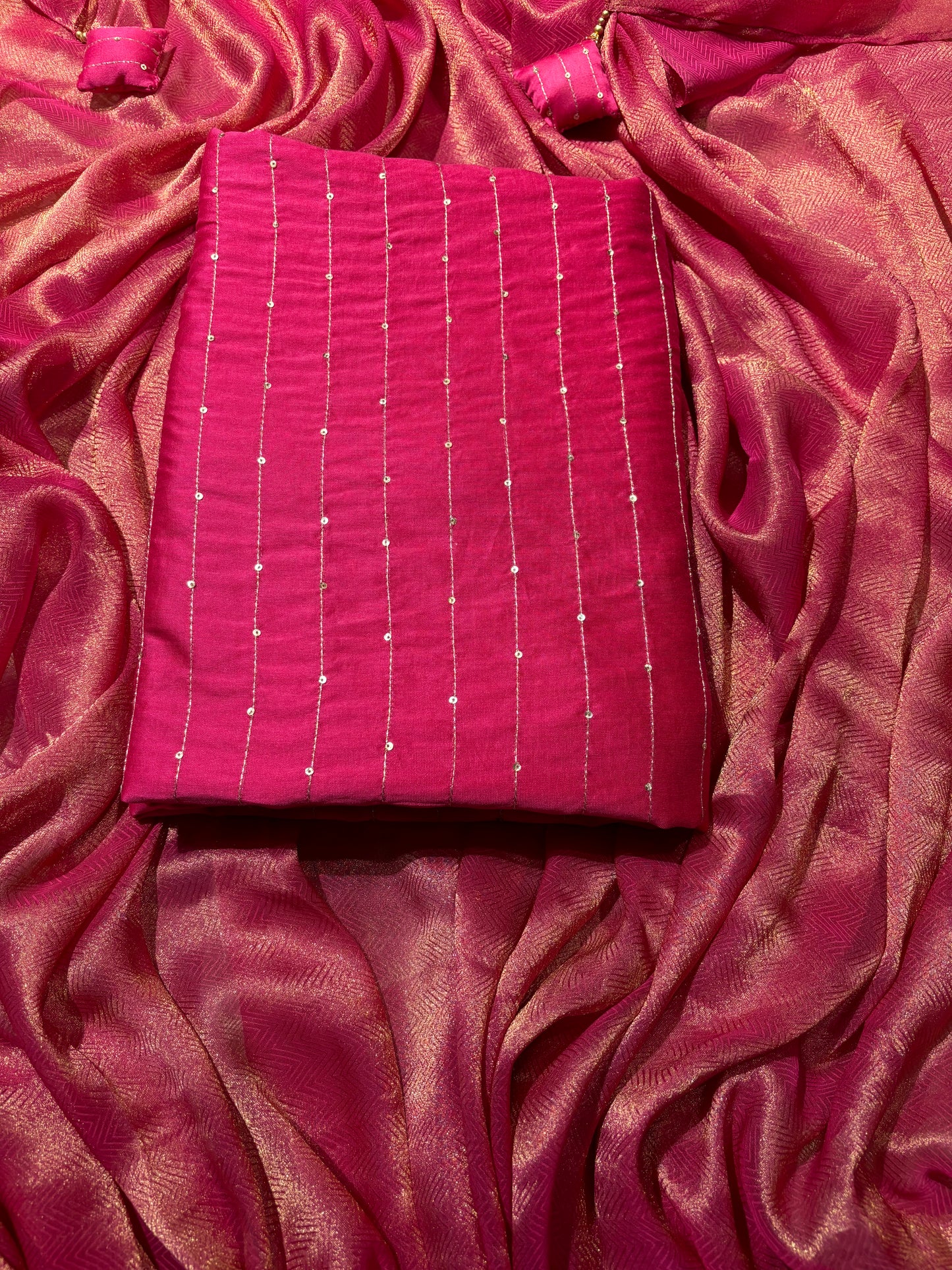 FUCHSIA CHANDERI SILK UNSTITCHED SUIT WITH ANCHORING AND SEQUINS WORK & TISSUE DRILL DUPATTA