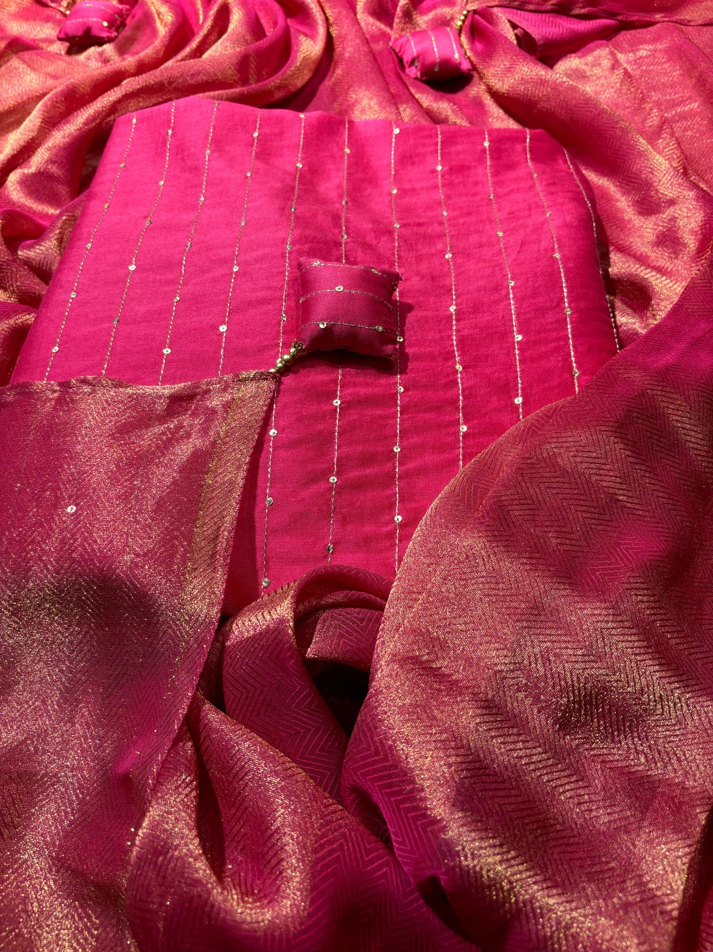 FUCHSIA CHANDERI SILK UNSTITCHED SUIT WITH ANCHORING AND SEQUINS WORK & TISSUE DRILL DUPATTA