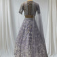 LAVENDER COLOR PAIRED WITH A CROP TOP CRAFTED DORI  AT THE BACK, FROM NET FABRIC IT FEATURES INTRICATE THREAD EMBROIDERY WITH MIRROR WORK AND PEARLS