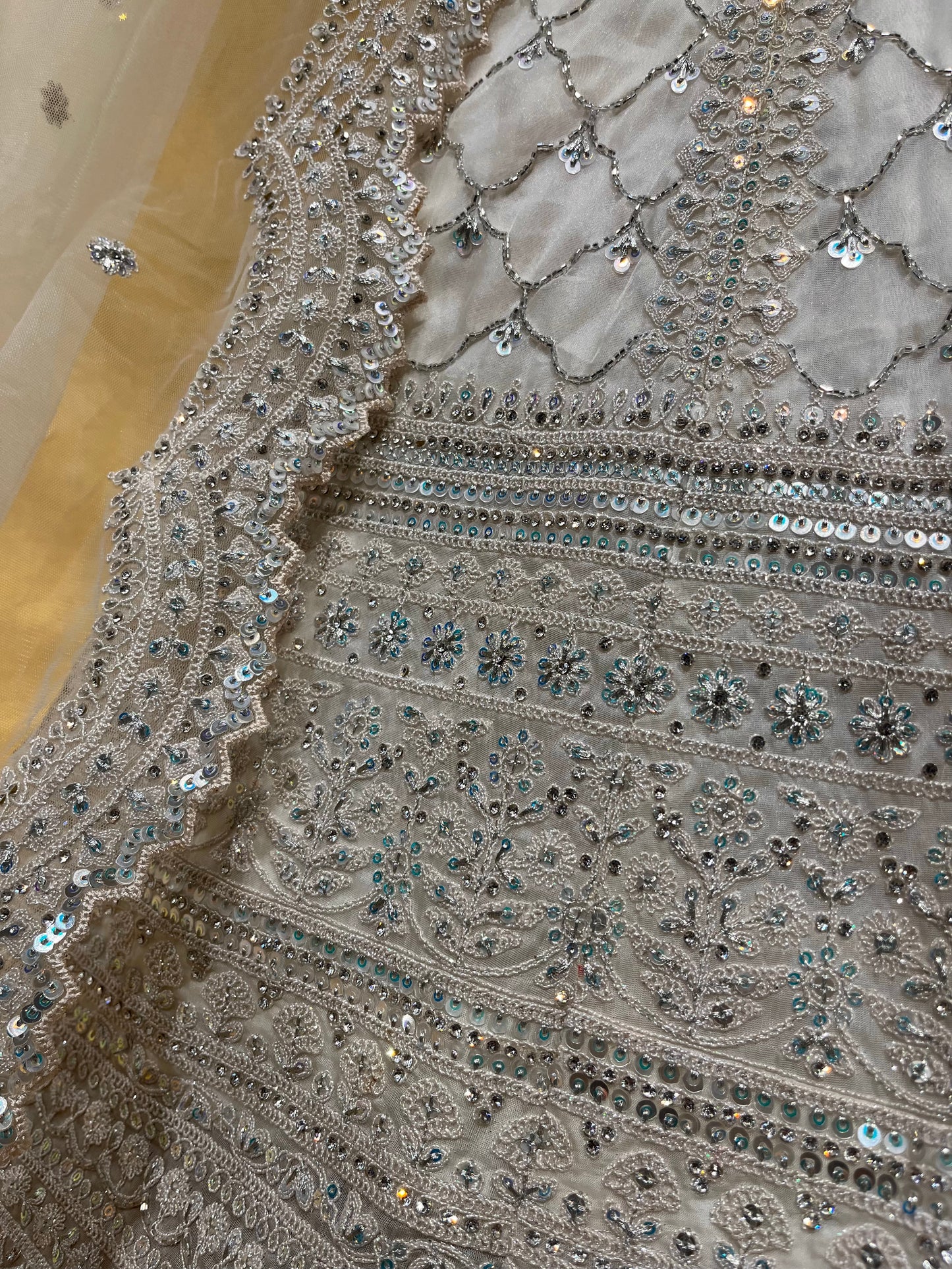 WHITE COLOUR ORGANZA EMBROIDERED LEHENGA WITH NET DUPATTA & UNSTITCHED BLOUSE EMBELLISHED WITH CUTDANA & SEQUINS WORK