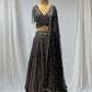 STUNNING BLACK SEQUIN LEHENGA FEATURING A V- NECK CROP TOP WITH EXQUISITE GOLDEN/SILVER SEQUINS WORK, IDEAL FOR A GLAMOROUS EVENING LOOK