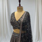 STUNNING BLACK SEQUIN LEHENGA FEATURING A V- NECK CROP TOP WITH EXQUISITE GOLDEN/SILVER SEQUINS WORK, IDEAL FOR A GLAMOROUS EVENING LOOK