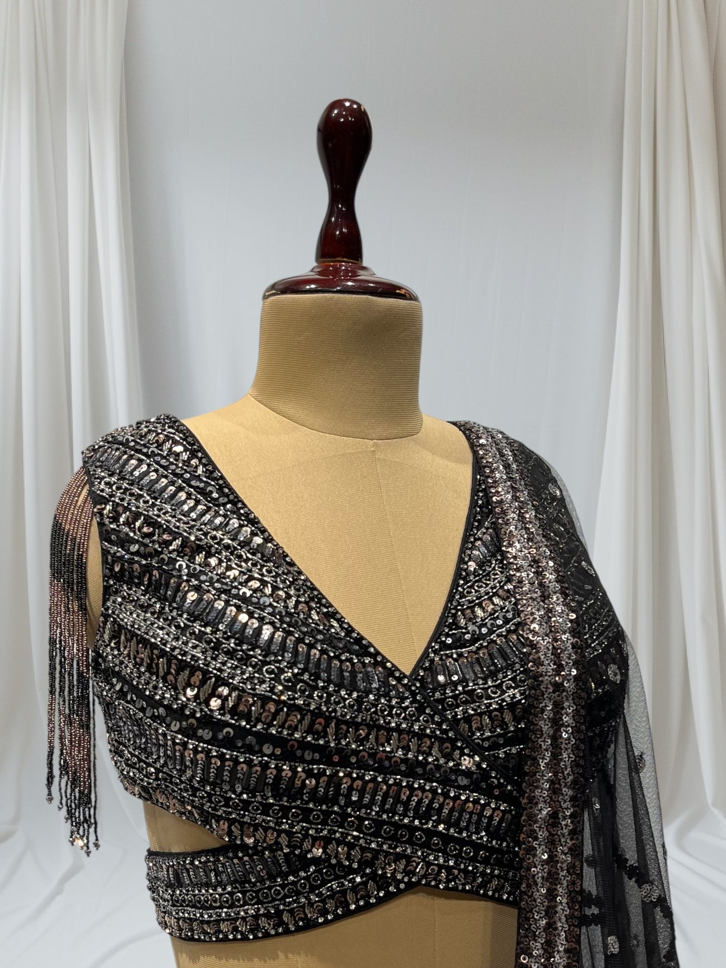 STUNNING BLACK SEQUIN LEHENGA FEATURING A V- NECK CROP TOP WITH EXQUISITE GOLDEN/SILVER SEQUINS WORK, IDEAL FOR A GLAMOROUS EVENING LOOK