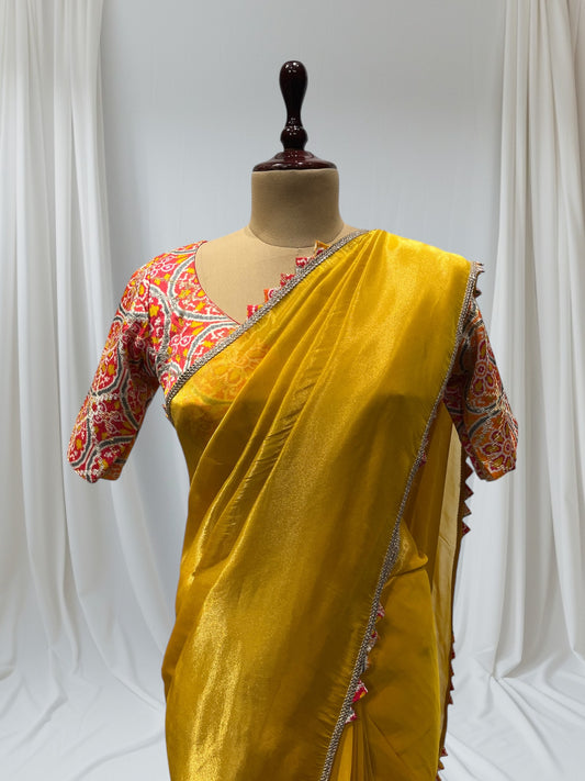 YELLOW SILK TISSUE SAREE WITH PATOLA PINK STITCHED BLOUSE, FEATURING ELEGANT GOTA BORDER, PERFECT FOR FESTIVE AND TRADITIONAL OCCASIONS