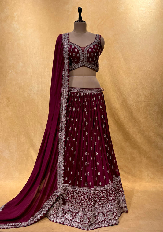 DARK WINE COLOUR CHINON LEHENGA WITH CROP TOP BLOUSE EMBELLISHED WITH CUTDANA, SEQUINS & ZARI EMBROIDERY