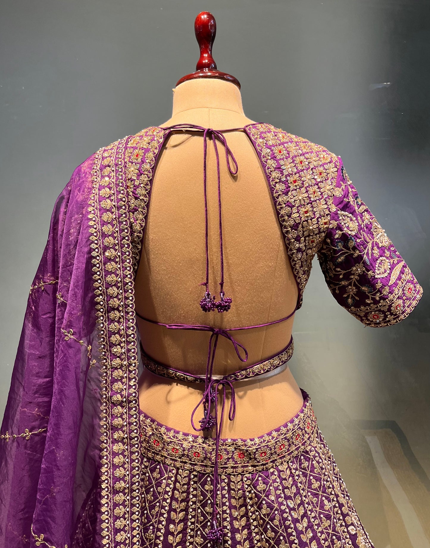 ( DELIVERY IN 20-25 DAYS ) PURPLE COLOUR SILK EMBROIDERED LEHENGA WITH ORGANZA DUPATTA EMBELLISHED WITH ZARI & SEQUINS WORK