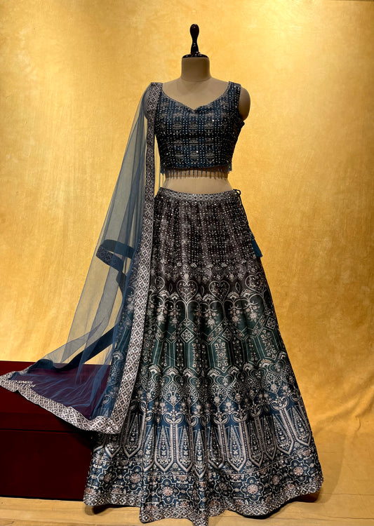 ( DELIVERY IN 15-20 DAYS ) BLUE & GREY COLOUR SILK LEHENGA WITH NET DUPATTA EMBELLISHED WITH MIRROR WORK