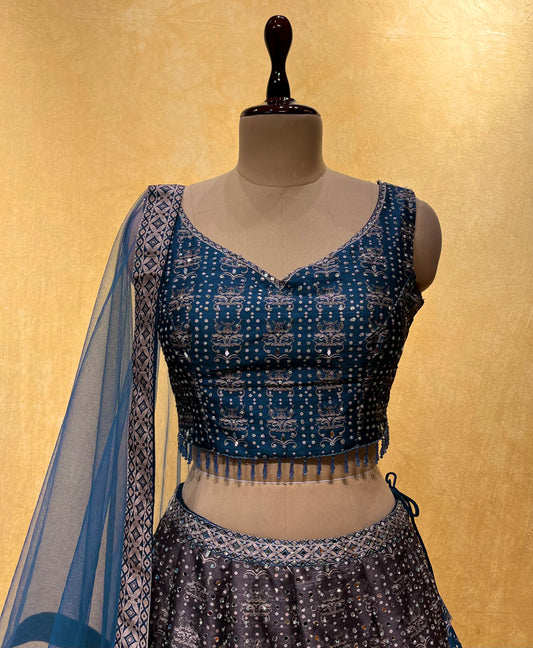 ( DELIVERY IN 15-20 DAYS ) BLUE & GREY COLOUR SILK LEHENGA WITH NET DUPATTA EMBELLISHED WITH MIRROR WORK