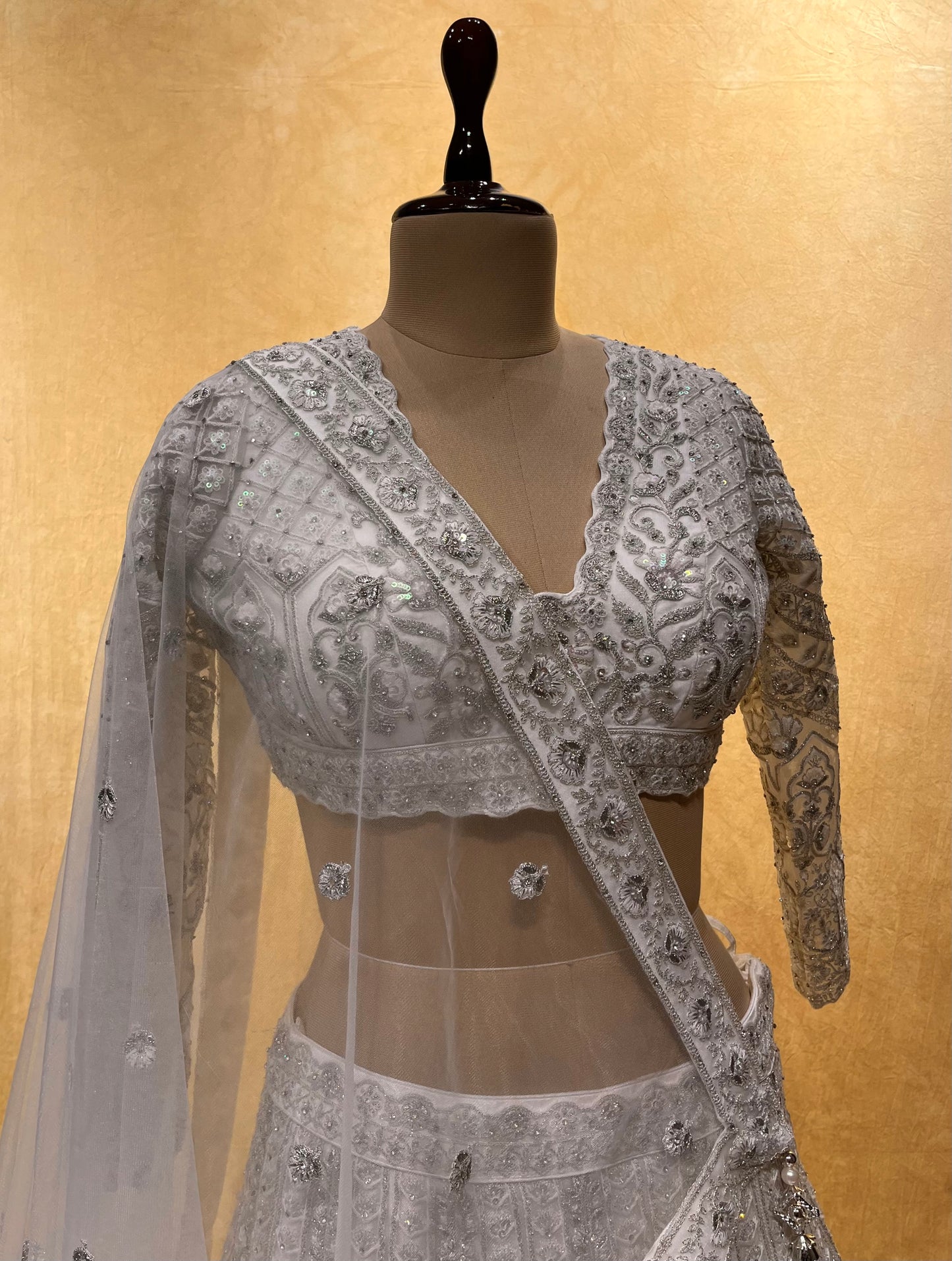WHITE COLOUR NET EMBROIDERED LEHENGA EMBELLISHED WITH SEQUINS & ZARI WORK