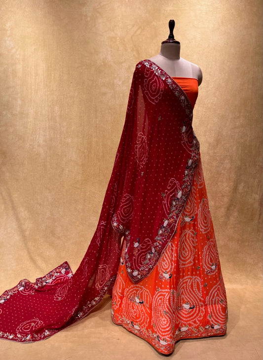 ( DELIVERY IN 25 DAYS ) ORANGE COLOUR PURE GEORGETTE OJARIYA BANDHEJ LEHENGA EMBELLISHED WITH GOTA PATTI & PEARL WORK