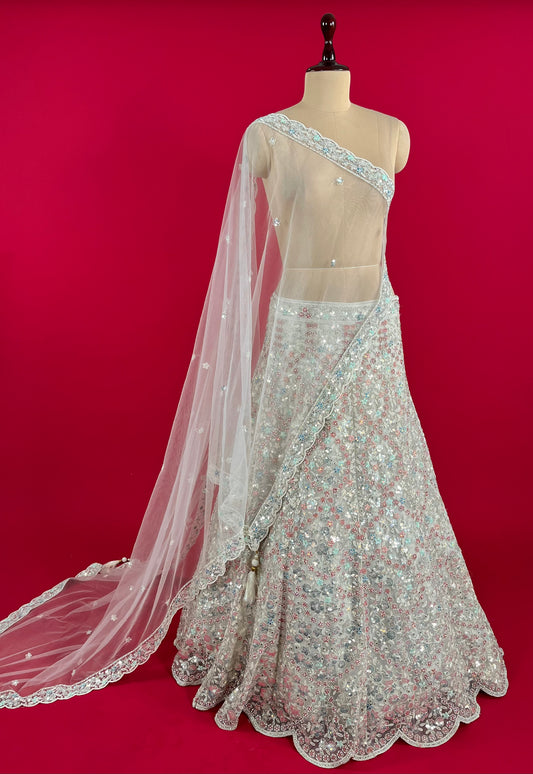 WHITE COLOUR NET SEQUINS EMBROIDERED LEHENGA WITH UNSTITCHED BLOUSE & NET DUPATTA EMBELLISHED WITH SEQUINS WORK