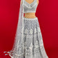 ( DELIVERY IN 25 DAYS ) GREY COLOUR NET HAND EMBROIDERED LEHENGA WITH READYMADE BLOUSE EMBELLISHED WITH SEQUINS & CUTDANA WORK