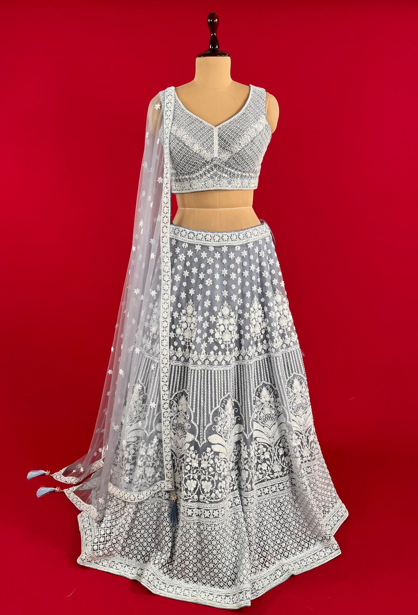 ( DELIVERY IN 25 DAYS ) GREY COLOUR NET HAND EMBROIDERED LEHENGA WITH READYMADE BLOUSE EMBELLISHED WITH SEQUINS & CUTDANA WORK