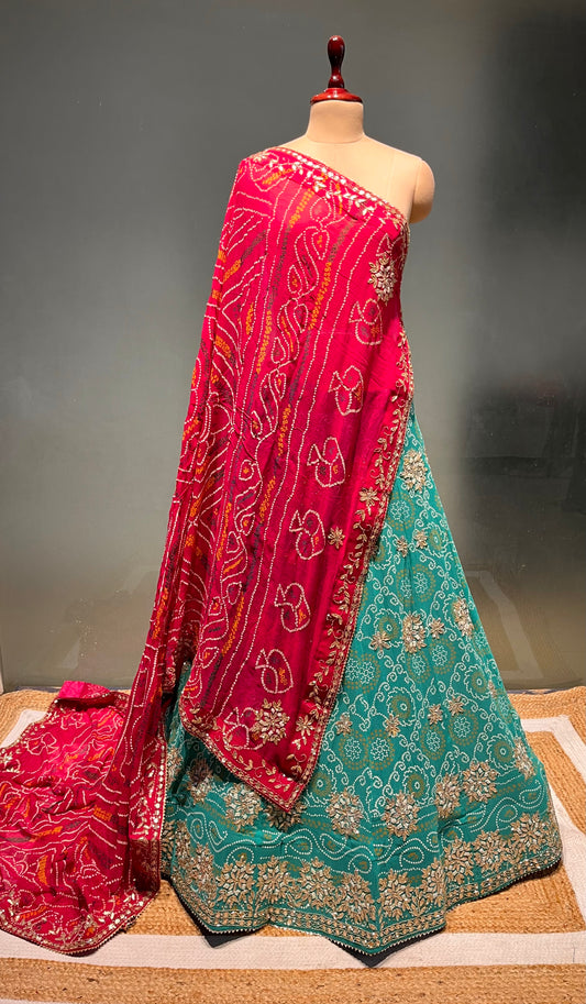 ( DELIVERY IN 20-25 DAYS ) TURQUOISE COLOUE GEORGETTE BANDHANI LEHENGA WITH UNSTITCHED BLOUSE EMBELLISHED WITH CUTDANA & GOTA PATTI WORK