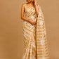 IVORY COLOUR CHANDERI GOLDEN STRIPED PARSI EMBROIDERED SAREE PAIRED WITH AN UNSTITCHED GOLDEN BLOUSE BY SIDDHAIKA - Kothari Sons
