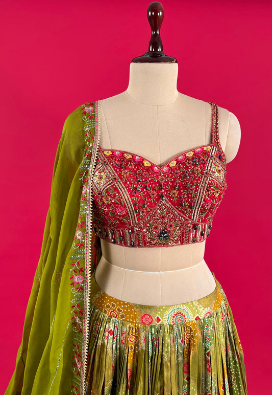 ( DELIVERY IN 25 DAYS ) MEHANDI GREEN COLOUR SKIRT WITH EMBROIDERED CROP TOP BLOUSE & ORGANZA DUPATTA EMBELLISHED WITH RESHAM, CUTDANA & SEQUINS WORK