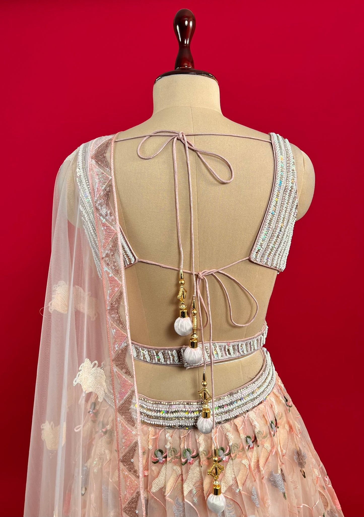 PEACH COLOUR NET SEQUINS EMBROIDERED SKIRT WITH READYMADE BLOUSE EMBELLISHED WITH BEADS & CUTDANA WORK