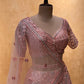 PEACH COLOUR NET EMBROIDERED LEHENGA WITH CROP TOP BLOUSE EMBELLISHED WITH MIRROR FOIL WORK