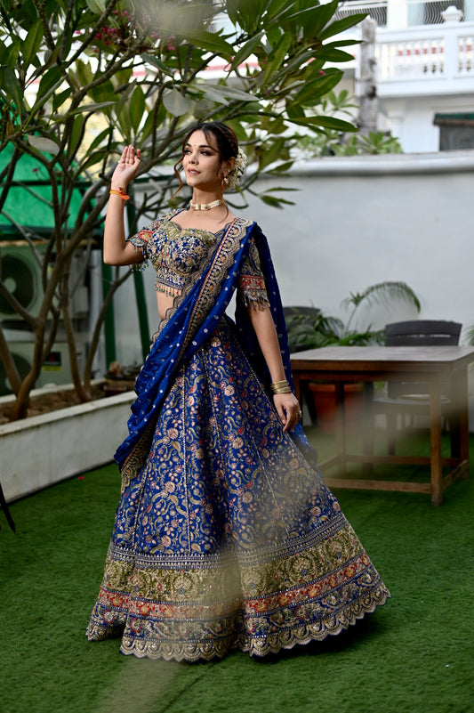 ROYAL BLUE COLOUR BANARASI LEHENGA WITH EMBROIDERED READYMADE BLOUSE & CHINON DUPATTA EMBELLISHED WITH SEQUINS, BEADS & KASAB EMBROIDERY