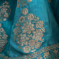 ( DELIVERY IN 25 DAYS ) TURQUOISE COLOUR BANARASI PURE SILK LEHENGA WITH UNSTITCHED BLOUSE EMBELLISHED WITH ZARIWEAVES