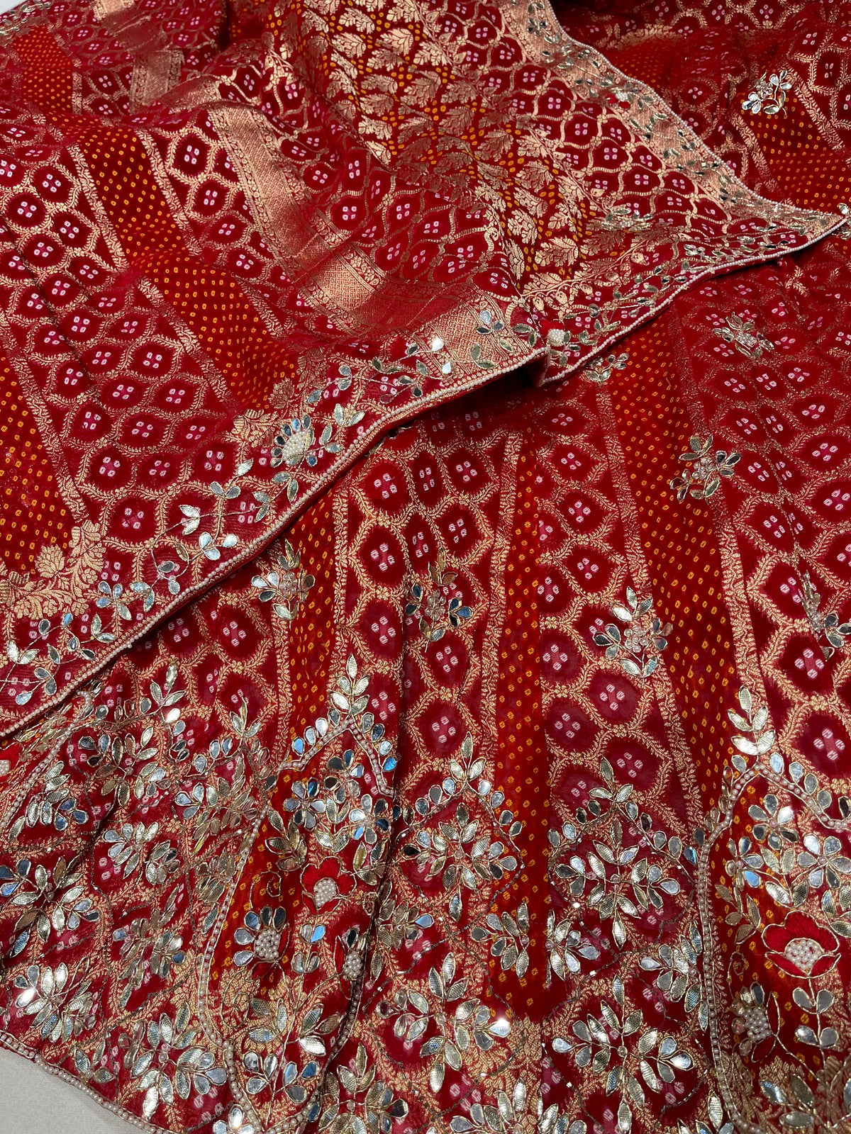 RED COLOUR KHADDI GEORGETTE BANDHANI LEHENGA WITH GOTA PATTI, MIRROR & ZARDOZI WORK & UNSTITCHED BLOUSE