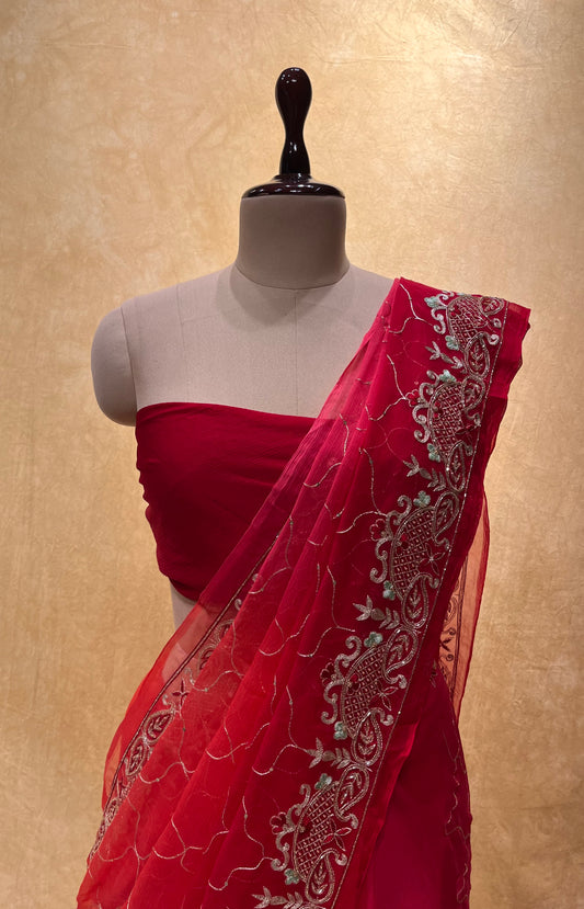 ( DELIVERY IN 20-25 DAYS ) RED SHADED PURE CHIFFON HAND EMBROIDERED SAREE EMBELLISHED WITH AARI & CUTDANA WORK