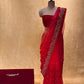 ( DELIVERY IN 20-25 DAYS ) RED SHADED PURE CHIFFON HAND EMBROIDERED SAREE EMBELLISHED WITH AARI & CUTDANA WORK