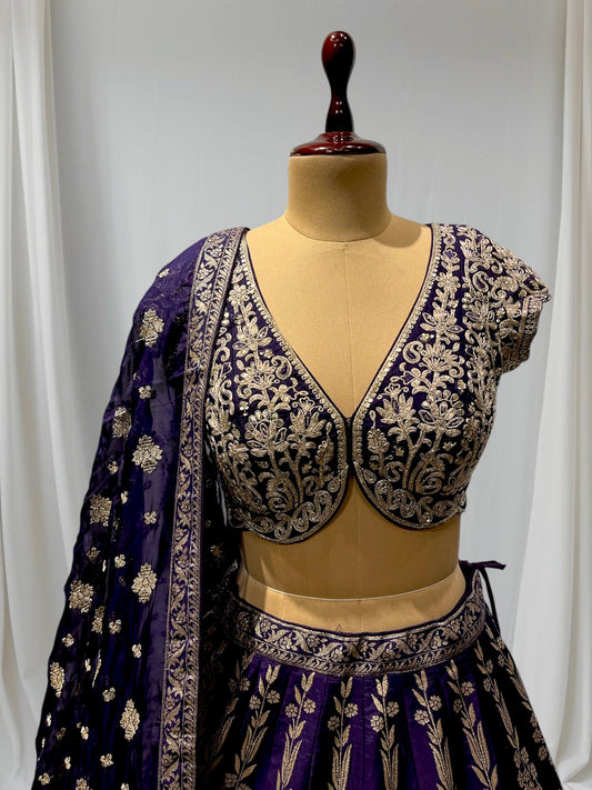 ( DELIVERY IN 20-25 DAYS ) PURPLE COLOR BANARASI LEHENGA WITH ORGANZA DUPPATTA EMBELLISHED WITH KASAB, CUTDANA AND SEQUINS WORK