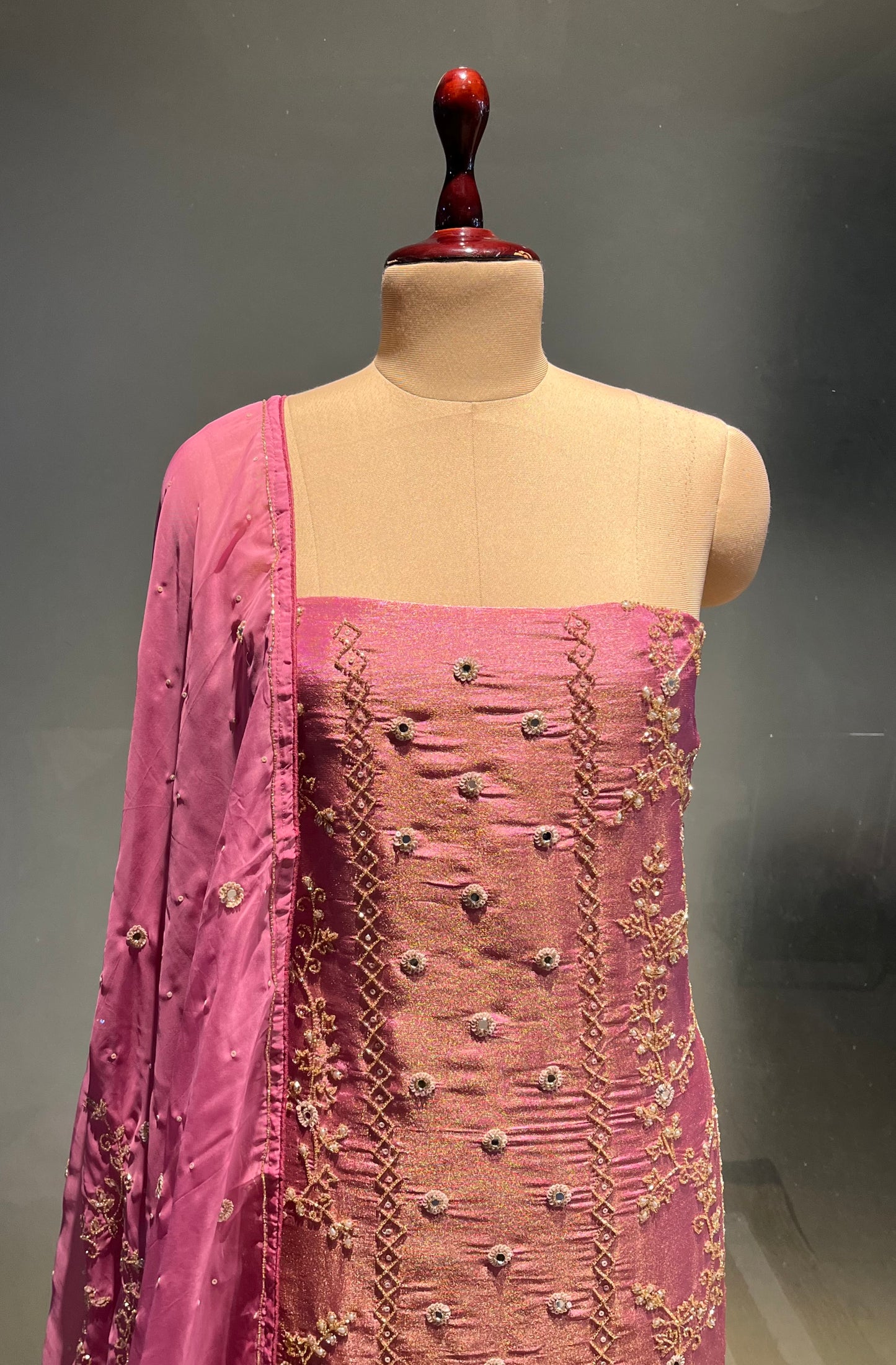PINK COLOUR CREPE TISSUE UNSTITCHED SUIT WITH ORGANZA DUPATTA EMBELLISHED WITH SEQUINS, CUTDANA & MIRROR WORK