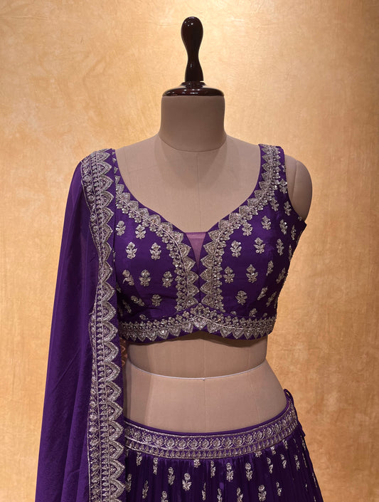 ( DELIVERY IN 15-20 DAYS ) PURPLE COLOUR CHINON LEHENGA WITH CROP TOP BLOUSE EMBELLISHED WITH CUTDANA, SEQUINS & ZARI WORK