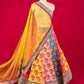 MULTI COLOUR RAW SILK FLORAL PRINTED LEHENGA WITH NET DUPATTA & UNSTITCHED BLOUSE EMBELLISHED WITH ZARI EMBROIDERY