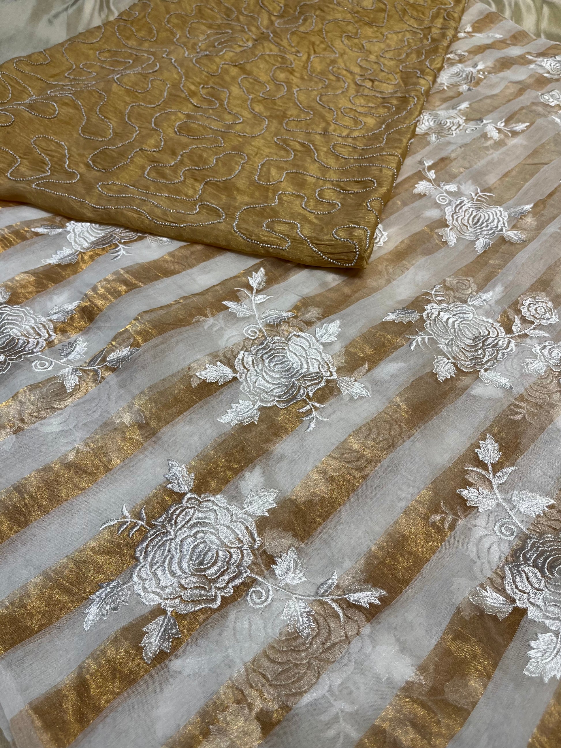 IVORY COLOUR CHANDERI GOLDEN STRIPED PARSI EMBROIDERED SAREE PAIRED WITH AN UNSTITCHED GOLDEN BLOUSE BY SIDDHAIKA - Kothari Sons