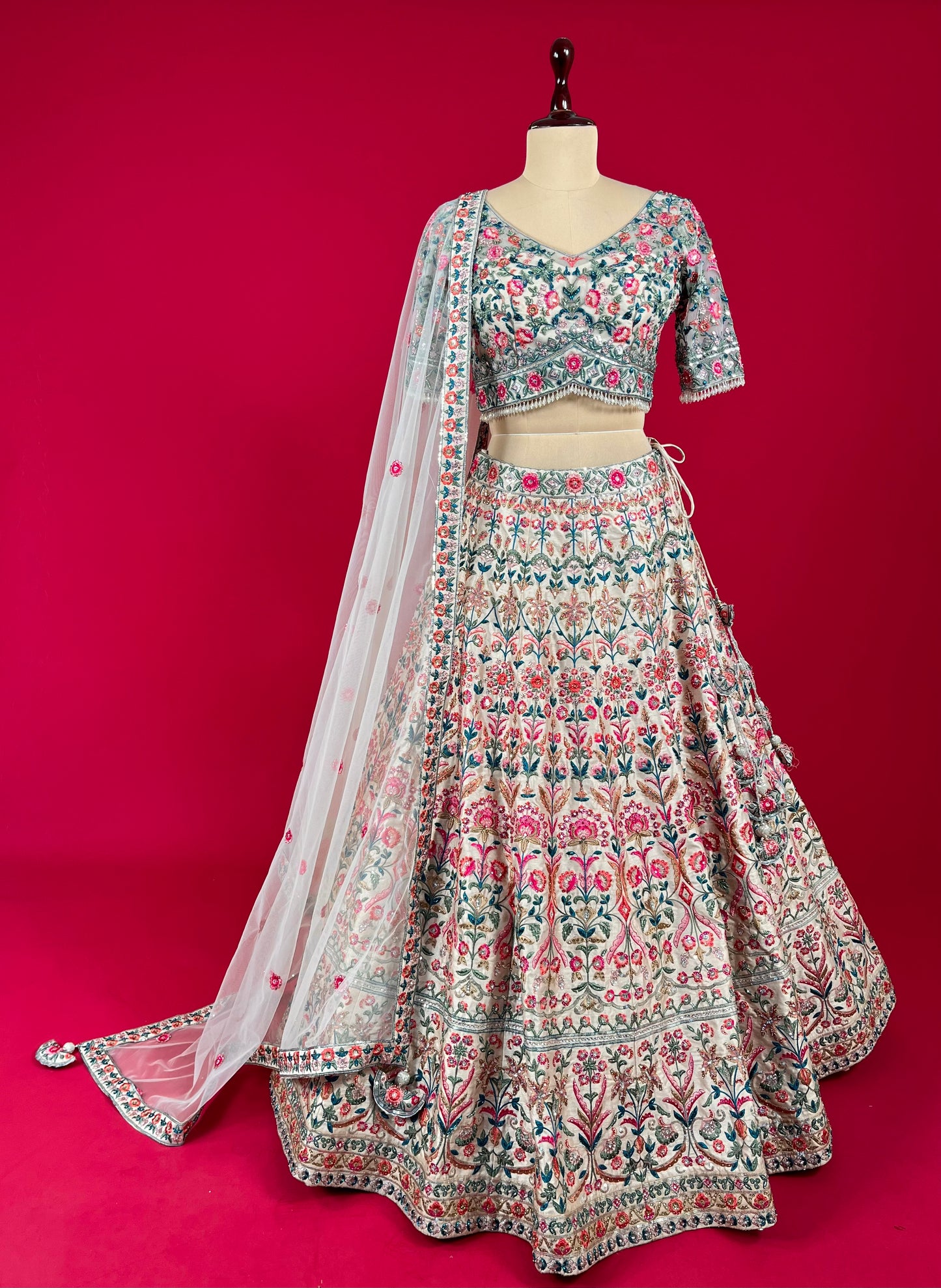 PEACH COLOUR SILK LEHENGA WITH EMBROIDERED BLOUSE & NET DUPATTA EMBELLISHED WITH RESHAM, CUTDANA & SEQUINS WORK