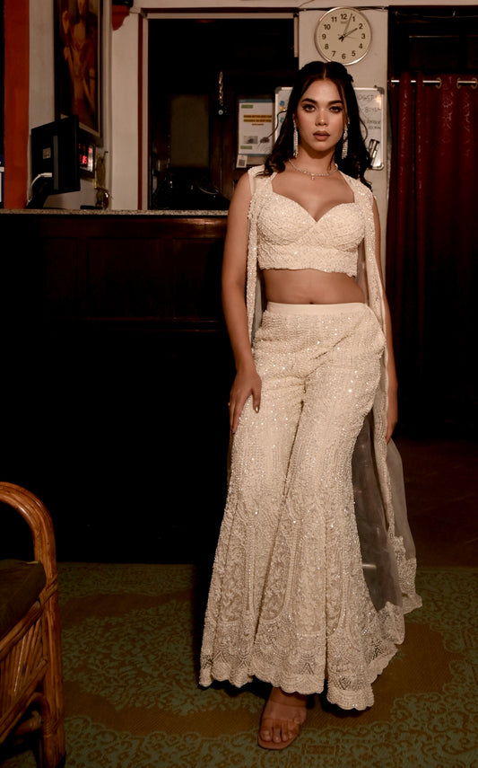 IVORY COLOUR NET HAND EMBROIDERED PALAZO PANT WITH CROP TOP & SHRUG EMBELLISHED WITH CUTDANA & SEQUINS WORK