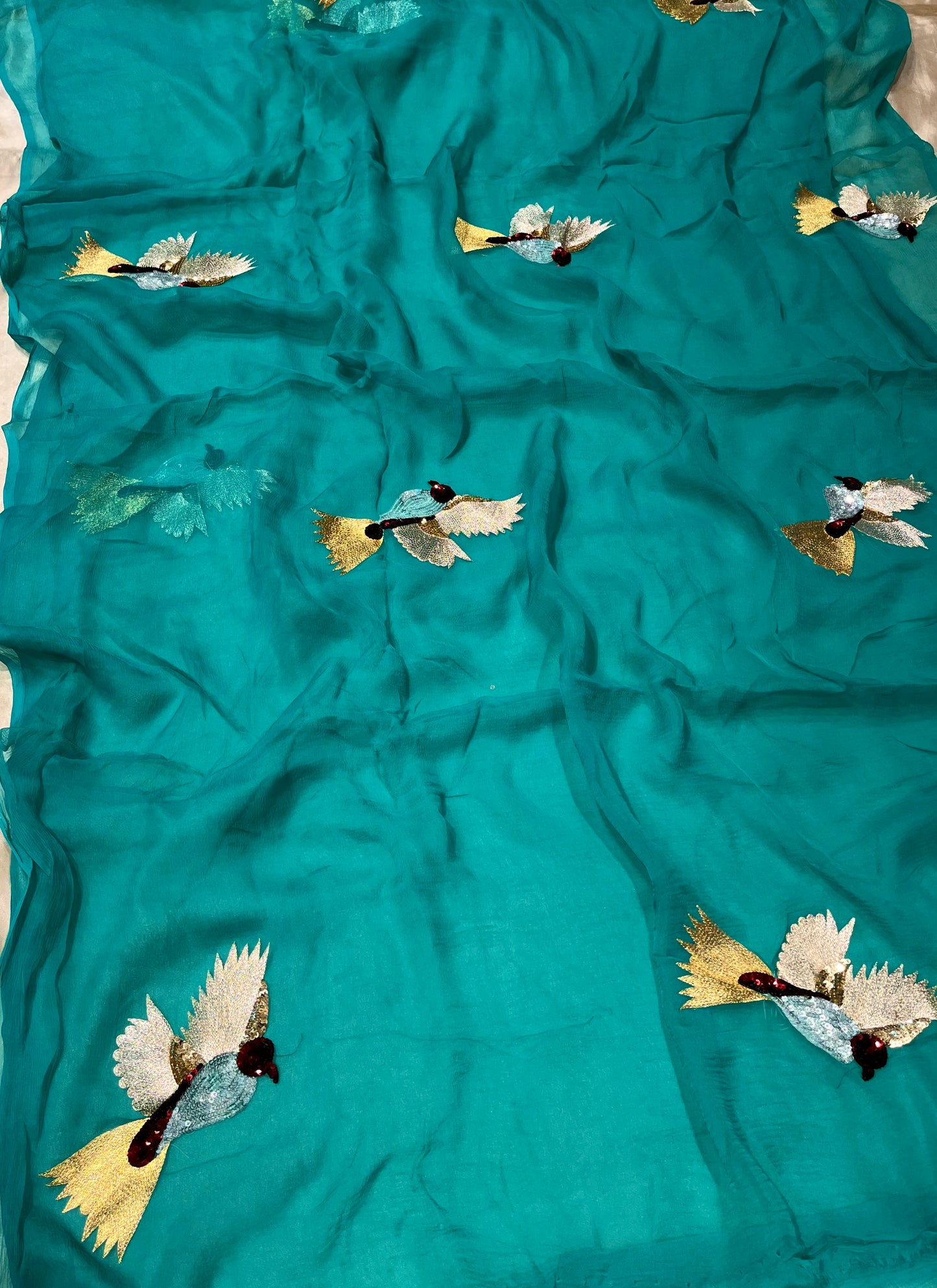 TURQUOISE COLOUR CHIFFON HAND EMBROIDERED SAREE EMBELLISHED WITH SEQUINS & AARI WORK