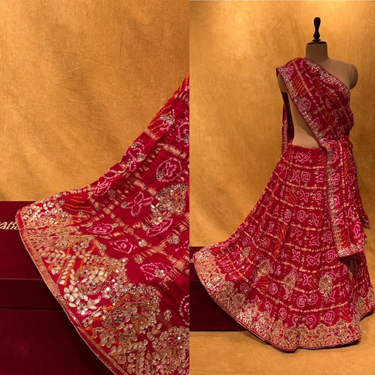 (DELIVERY IN 20-25 DAYS) RED COLOUR BANDHANI BANDHEJ GHARCHOLA LEHENGA EMBELLISHED WITH HAND EMBROIDERY