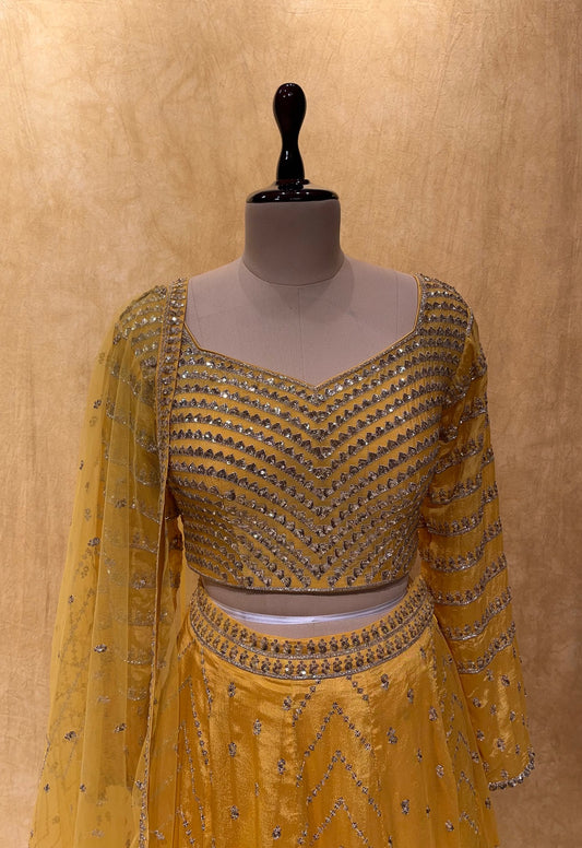 (DELIVERY IN 25 DAYS) YELLOW COLOUR CHINON LEHENGA WITH NET DUPATTA EMBELLISHED WITH SEQUINS WORK